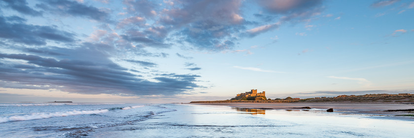 Bamburgh Castle 
 www.keithmuirphoto.co.uk 
 Keywords: Bamburgh, England, Northumbria, beach, clouds, coast, dusk, landscapes, reflections, sea, seascapes, shore, sunset, waves